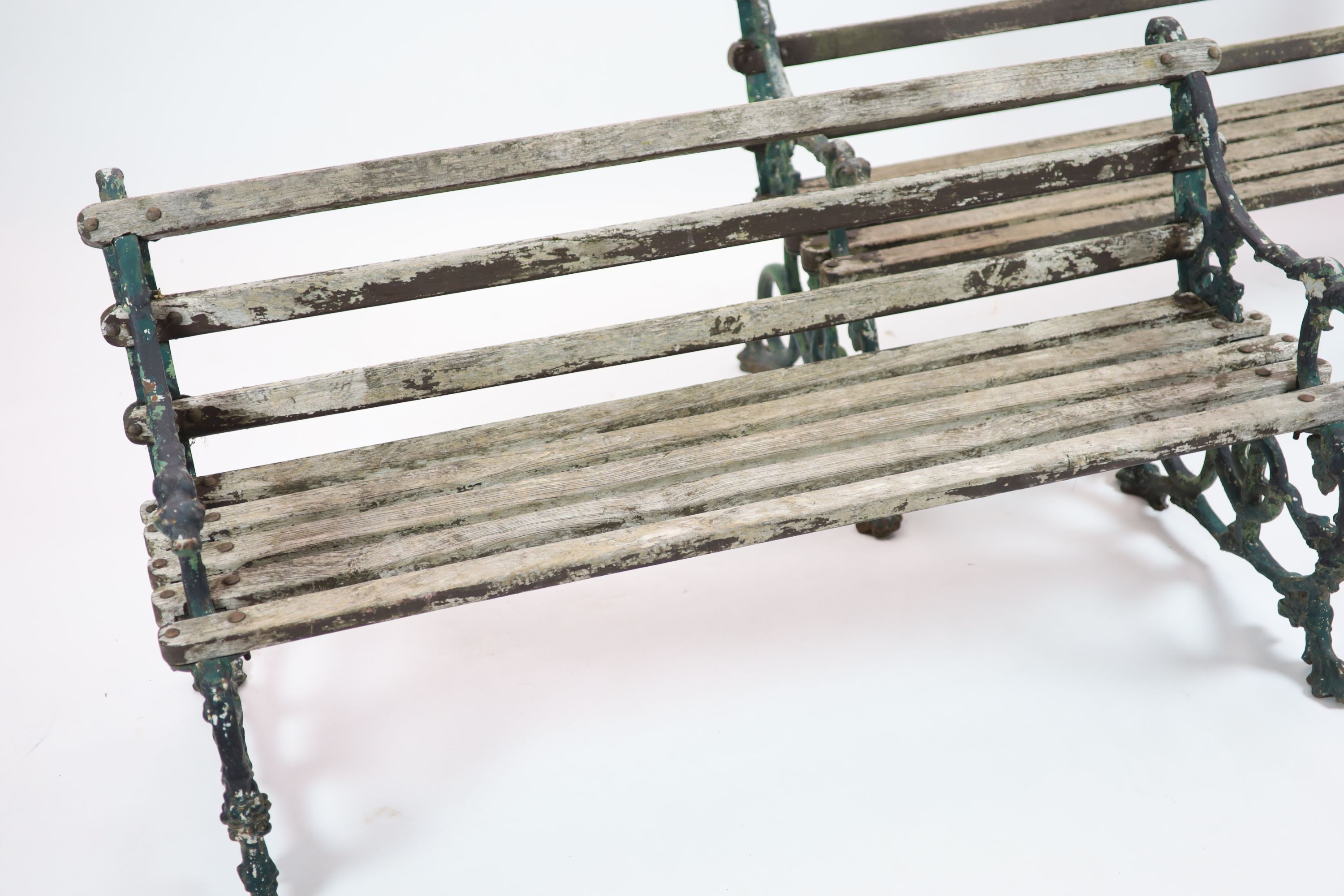 A pair of Victorian Coalbrookdale cast iron 'Grape and serpent' garden benches H 76cm. W 160cm. D 64cm.